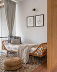 A serene bedroom setting featuring the Indigo Reverie Quilt, handwoven in cotton and adorned with delicate hand block-printed floral motifs in a soothing indigo hue. Layered with coordinating pillows and curtains, this arrangement exudes timeless elegance, bringing a touch of artisanal craftsmanship and refined comfort to the space.