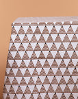 The Black Triangles Tablecloth showcases a bold geometric design, featuring meticulously arranged black and brown triangular patterns on a crisp white base. Crafted from premium cotton, its striking symmetry adds a modern touch to any dining space, making it a statement piece for both casual and elegant settings.