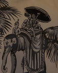 A handcrafted cushion, featuring the Heritage Threads Cushion Cover depicting a black and white Mughal elephant procession, from Idli by Thierry Journo. A fusion of heritage craftsmanship and contemporary design, each piece tells a unique story.