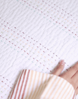 A close-up of the Kantha Textured Stories Bedspread, showcasing its intricate hand-stitched detailing. The delicate, multicolored Kantha embroidery adds depth and charm to the soft, quilted texture, celebrating the beauty of handcrafted tradition.