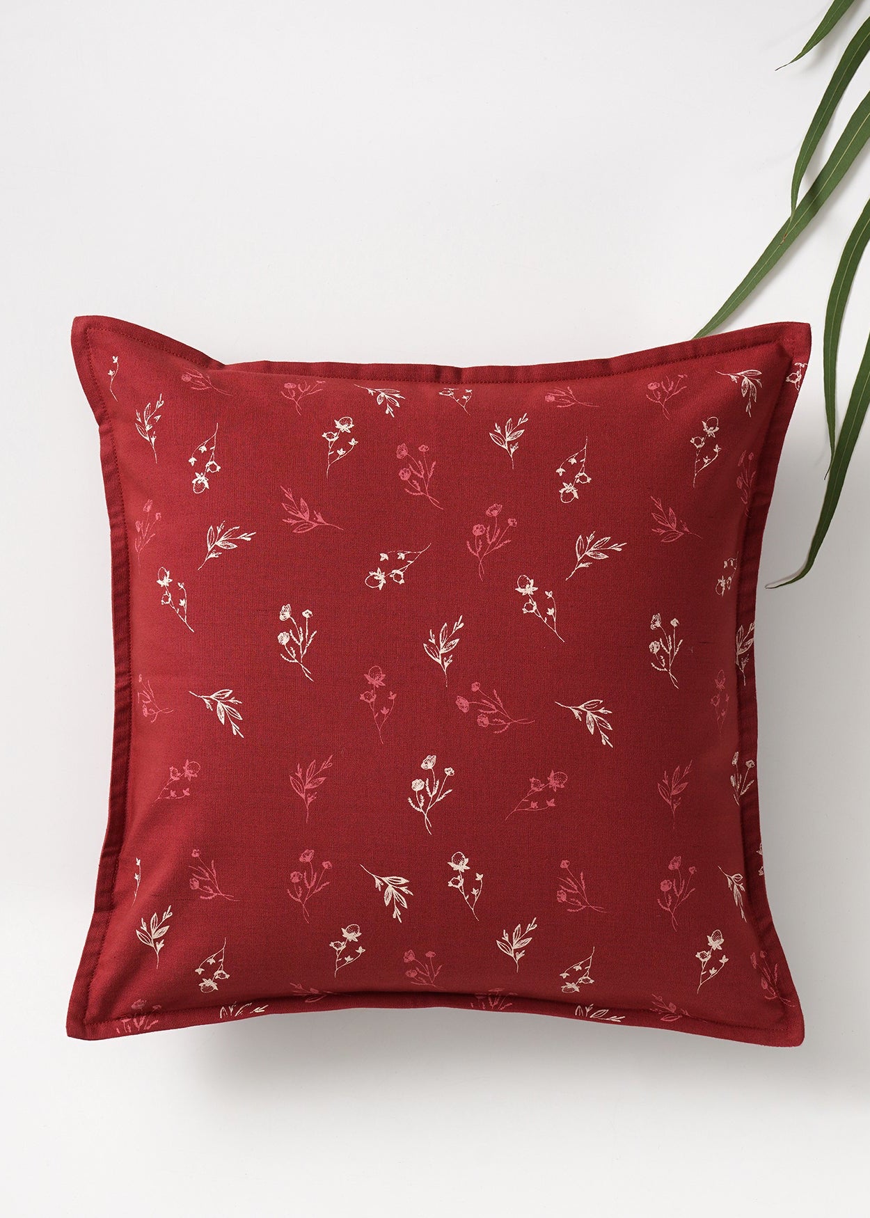  Cushion Cover – A charming cotton cushion cover in a deep red hue, delicately block-printed with floral motifs. The soft, breathable cotton fabric and traditional hand-block printing technique bring warmth and character, making it a perfect accent piece for cozy, timeless interiors