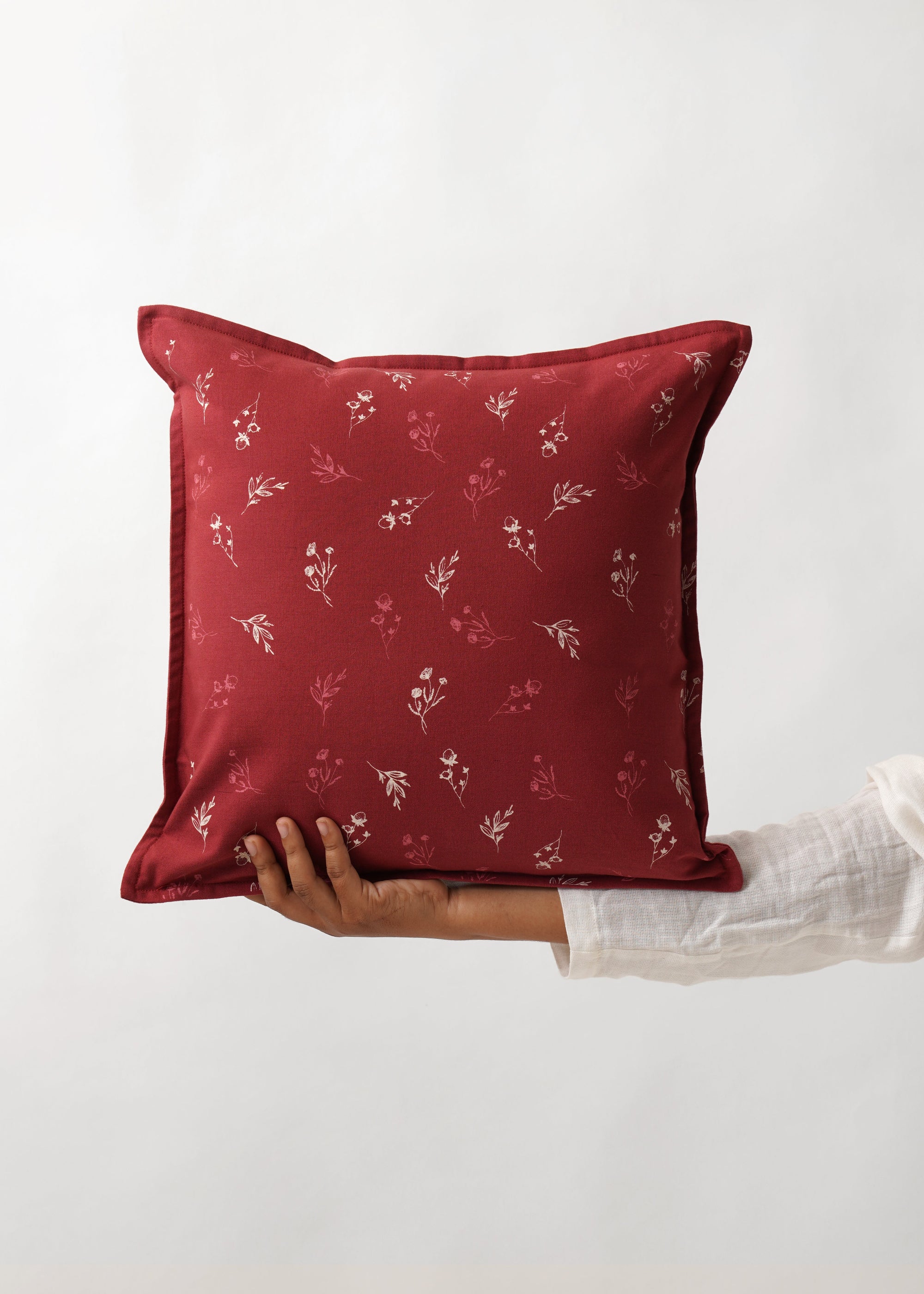  Cushion Cover – A charming cotton cushion cover in a deep red hue, delicately block-printed with floral motifs. The soft, breathable cotton fabric and traditional hand-block printing technique bring warmth and character, making it a perfect accent piece for cozy, timeless interiors