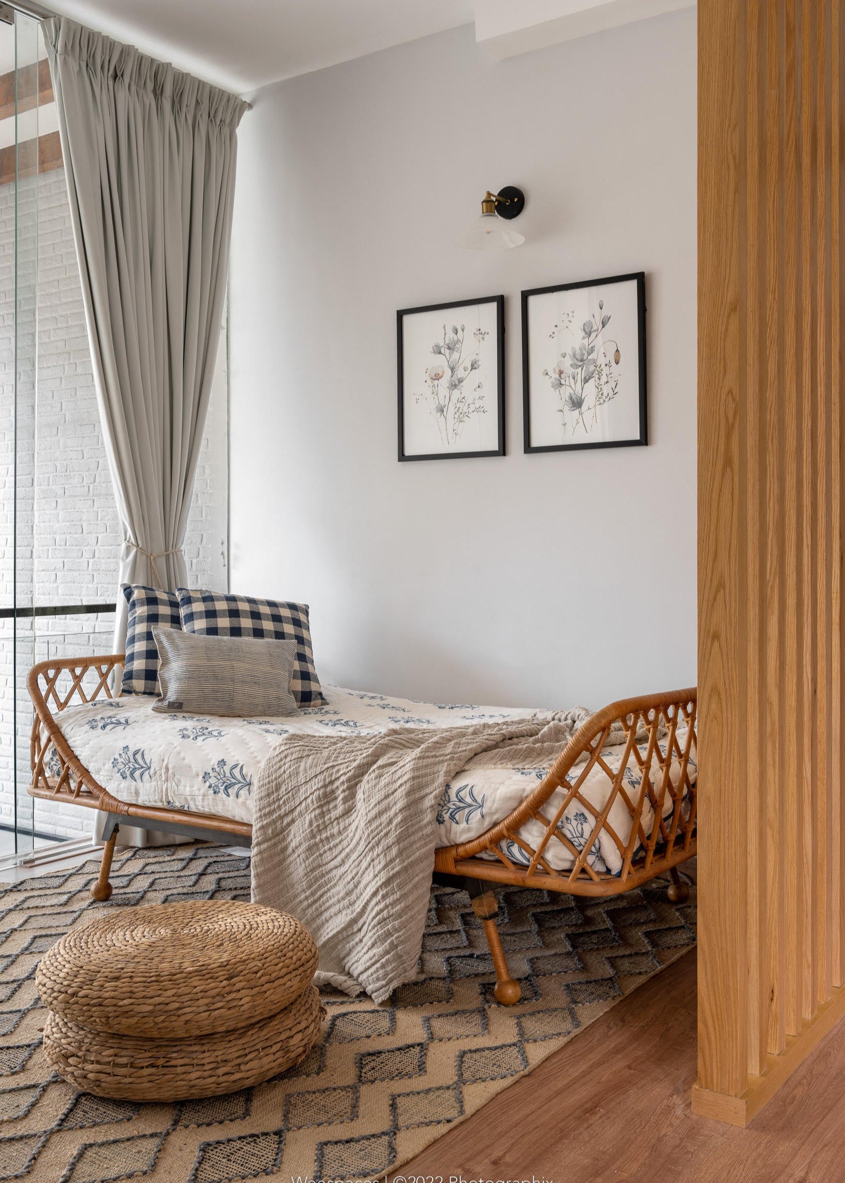 A serene bedroom setting featuring the Indigo Reverie Quilt, handwoven in cotton and adorned with delicate hand block-printed floral motifs in a soothing indigo hue. Layered with coordinating pillows and curtains, this arrangement exudes timeless elegance, bringing a touch of artisanal craftsmanship and refined comfort to the space.