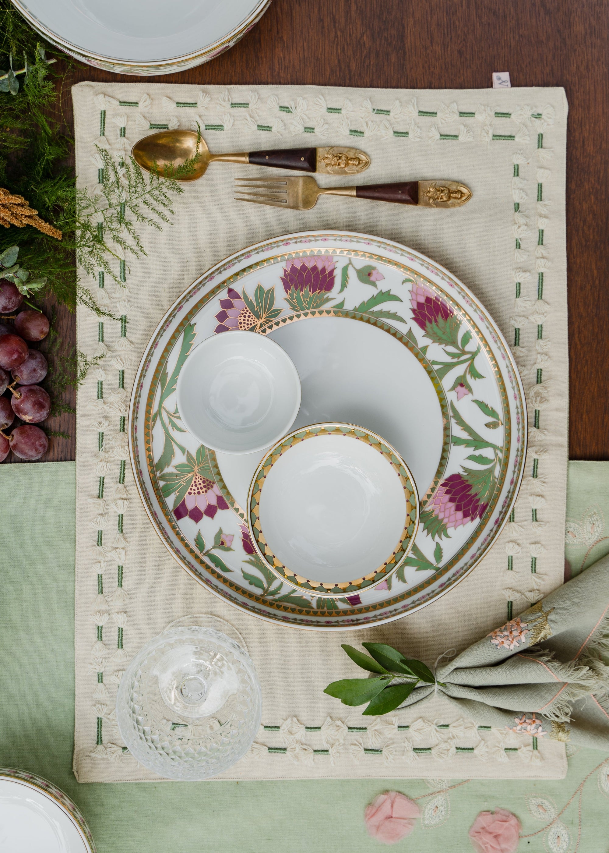 assled Table Mat – A handwoven cotton table mat, beautifully adorned with hand embroidery and delicate tassel details. Its intricate craftsmanship and refined texture bring an elegant yet artisanal charm to any dining setting.