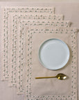 Tassled Table Mat – This handwoven cotton table mat is elevated with delicate hand embroidery and tassel detailing, creating a refined yet artisanal touch for your dining space. Its soft texture and intricate craftsmanship add warmth and sophistication to every meal.