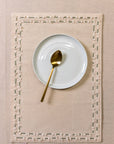 Tassled Table Mat – This handwoven cotton table mat is elevated with delicate hand embroidery and tassel detailing, creating a refined yet artisanal touch for your dining space. Its soft texture and intricate craftsmanship add warmth and sophistication to every meal.