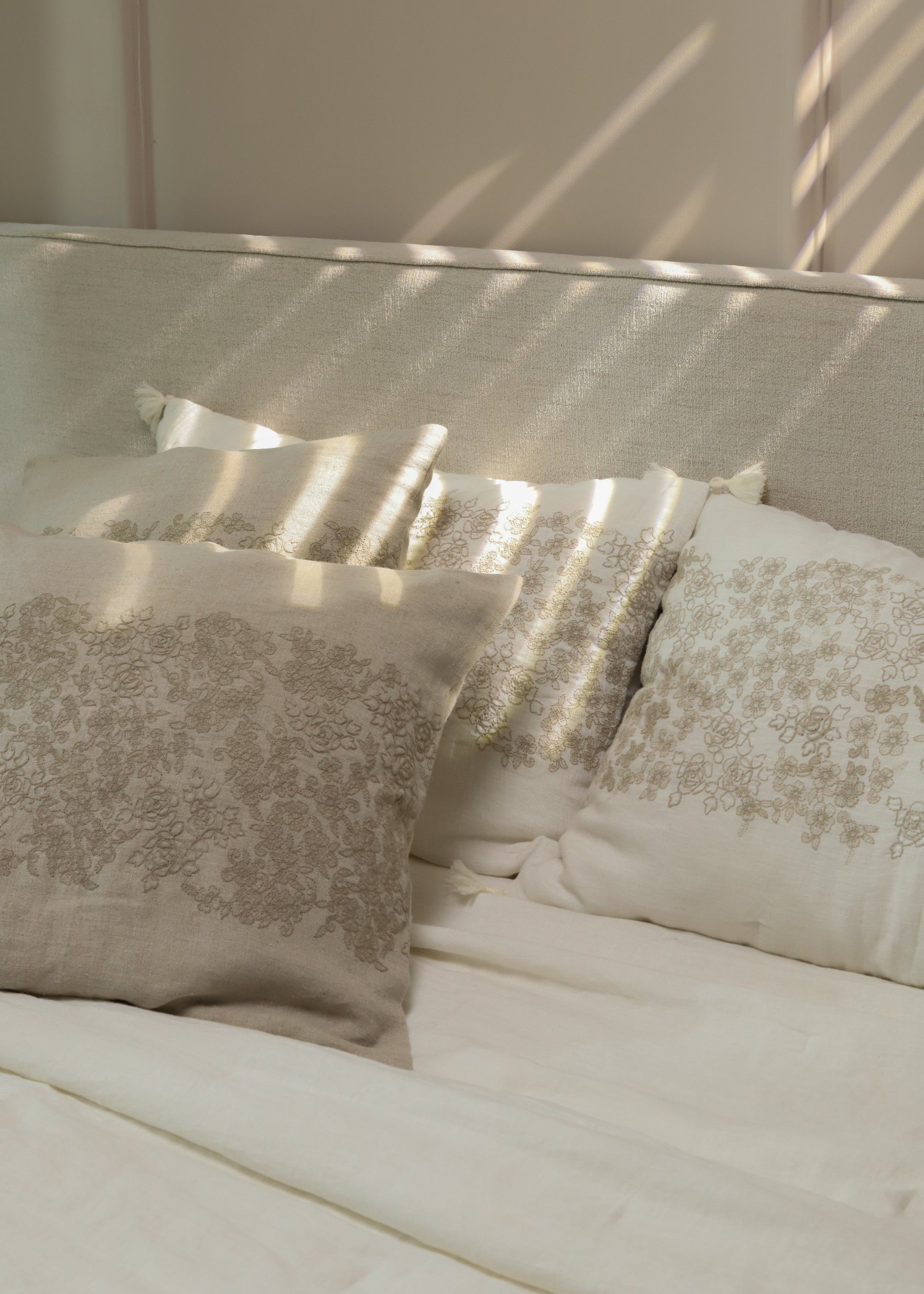 The Solara Linen Bedspread, a handwoven masterpiece that blends natural elegance with intricate embroidery. Its soft linen texture and delicate floral patterns add warmth and serenity to any bedroom, catching the morning light beautifully.