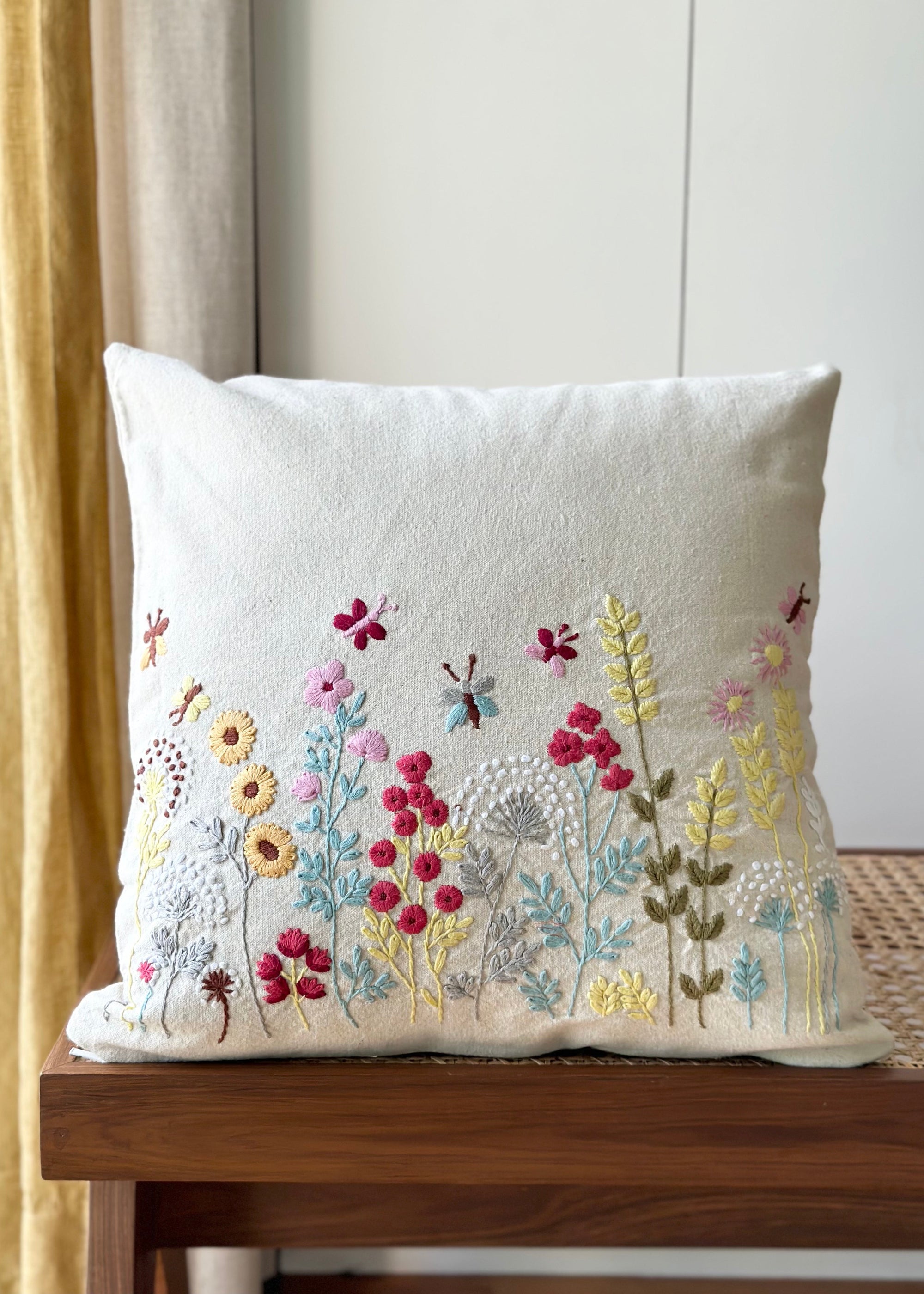 Flourish Embroidery Cushion Cover – A beautifully handwoven cotton cushion cover featuring intricate hand embroidery. Every floral detail is meticulously stitched, bringing texture and artistry to life. A true celebration of craftsmanship, adding warmth and elegance to any space.