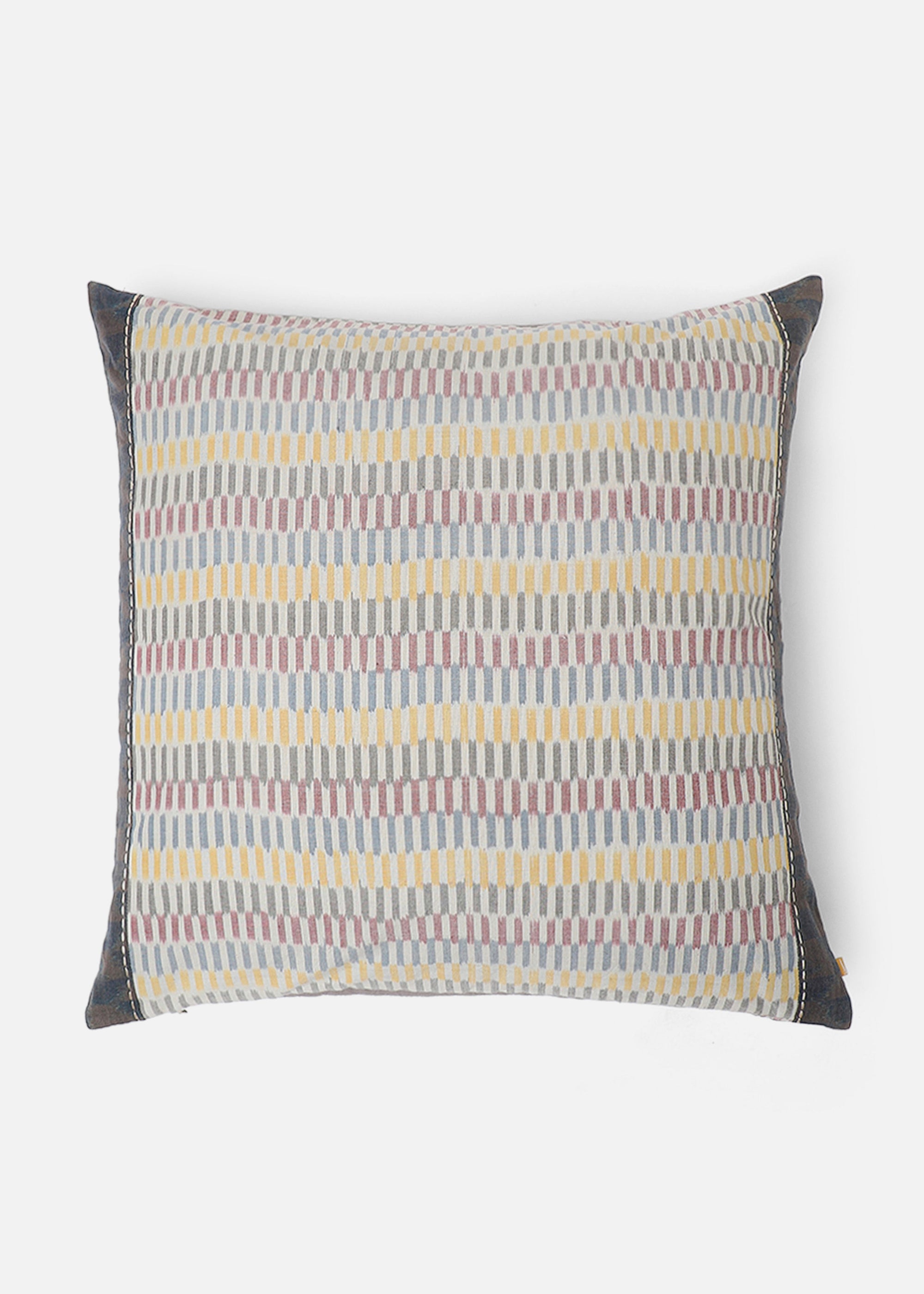 Sofia Cushion Cover – A beautifully handwoven cotton cushion cover featuring a subtle ikat-inspired pattern in warm, earthy tones of yellow, grey, and burgundy. Finished with delicate hand-stitched detailing and a contrasting dark-hued border, this piece embodies craftsmanship and understated elegance. Perfect for adding texture and character to any living space.