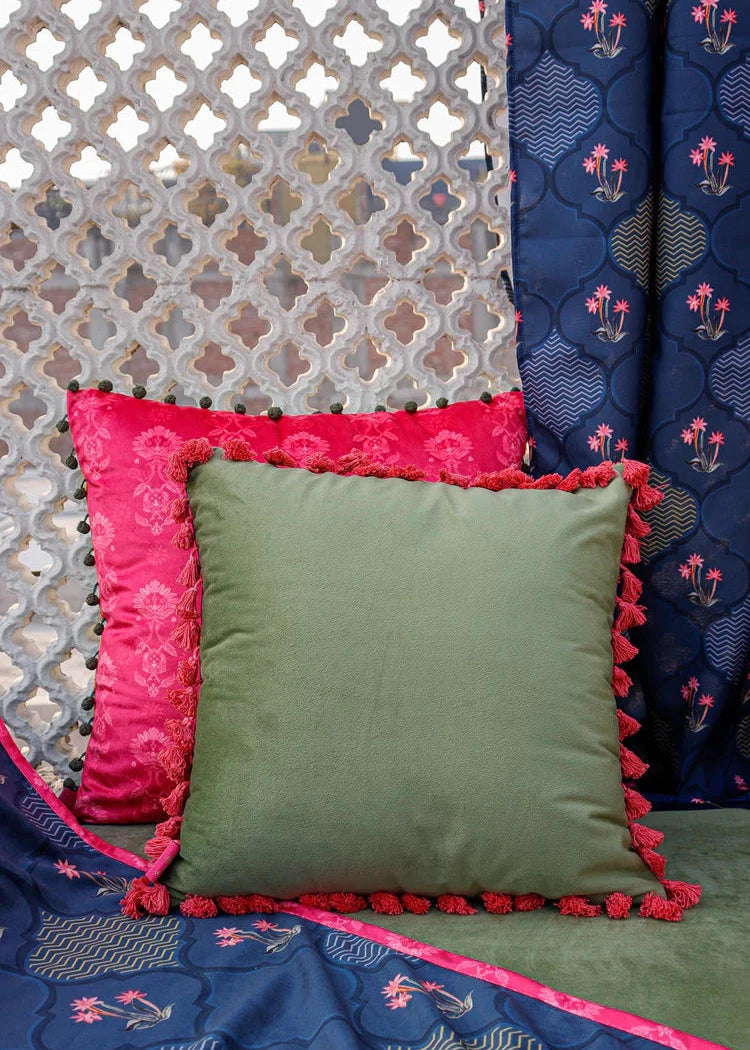 Nargis Cushion Cover – A luxurious fusion of cotton and velvet, this cushion cover features an intricate floral and geometric motif in rich navy blue, highlighted with delicate pink accents. Handcrafted with exceptional detail, its plush texture and vibrant tassel edging add a regal charm to any space.