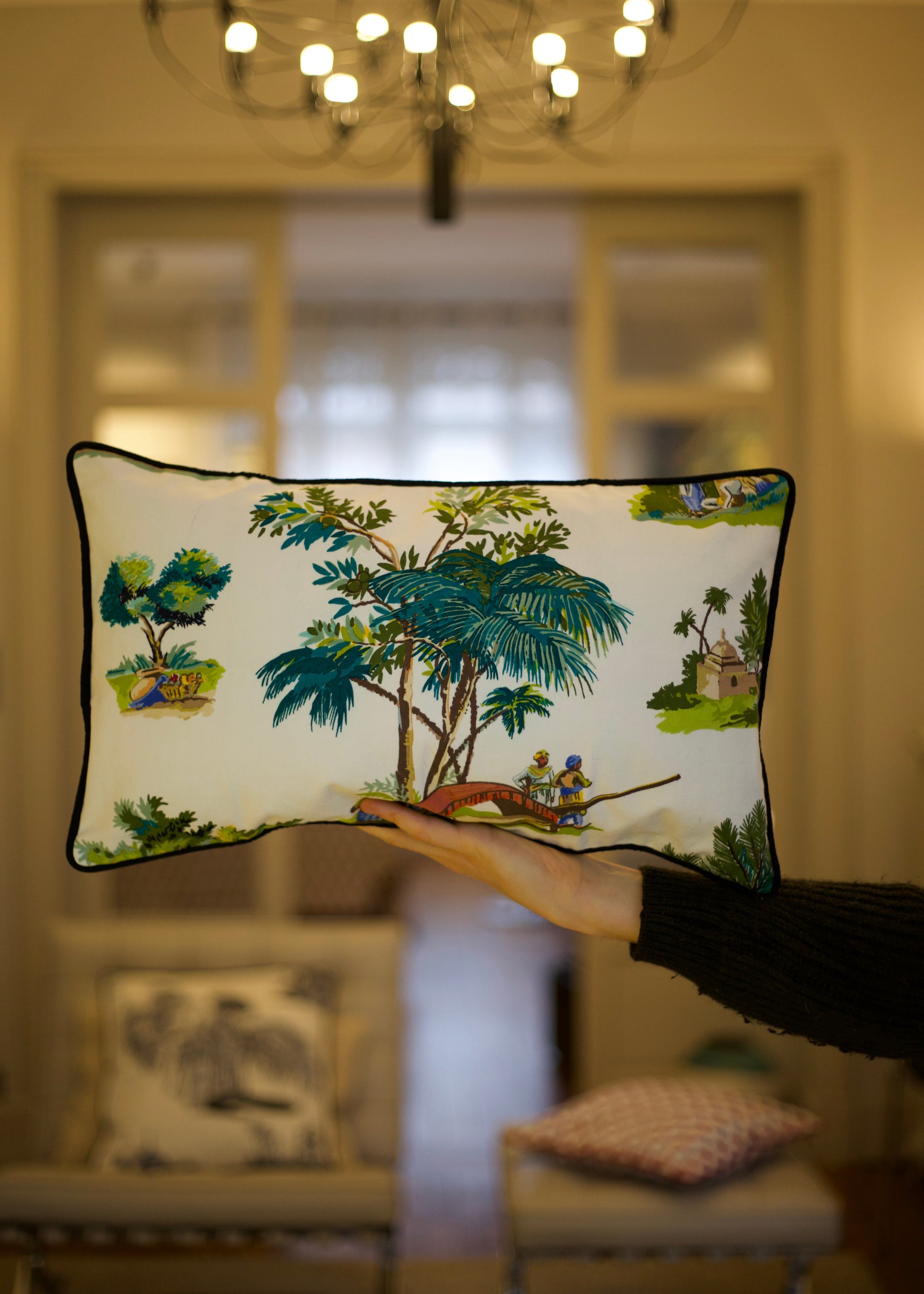 A handcrafted cushion resting, featuring the Mughal Orchard Cushion Cover from Idli by Thierry Journo. A fusion of heritage craftsmanship and contemporary design, each piece tells a unique story.