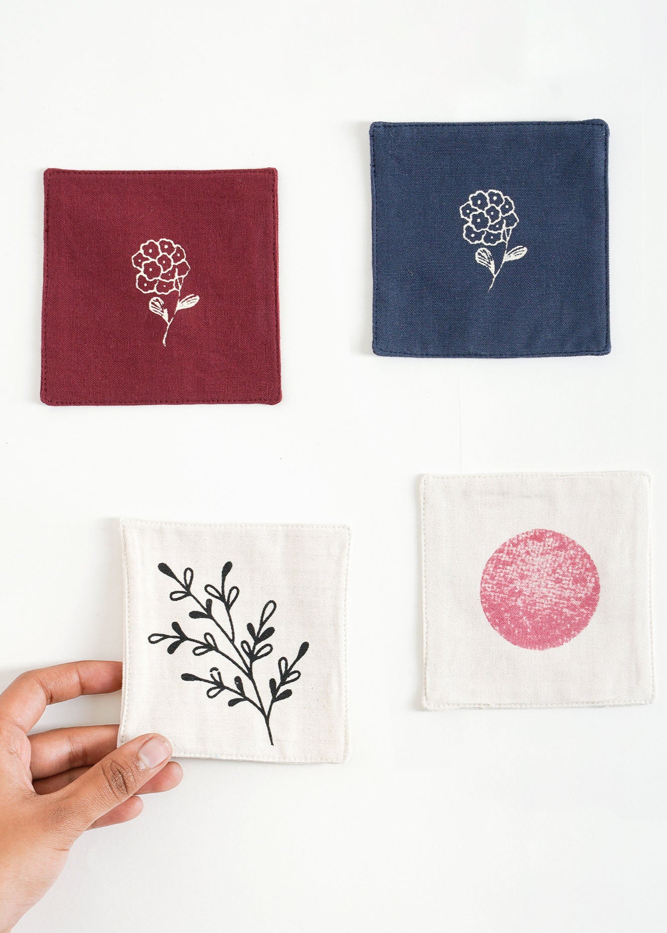 Handcrafted Cotton Coasters – A set of handwoven cotton coasters, featuring hand block-printed floral and abstract designs. Each piece is carefully crafted, bringing a refined yet natural touch to your table setting. Perfect for adding warmth and artistry to your daily moments.