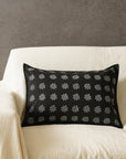Tara Bloom Cushion Cover – A sophisticated black cushion cover made of cotton, adorned with delicate silver floral motifs, hand-block printed for a timeless appeal. Crafted from high-quality cotton, its refined elegance and monochrome contrast make it a versatile addition to any modern or classic home setting.