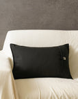 Tara Bloom Cushion Cover – A sophisticated black cushion cover made of cotton, adorned with delicate silver floral motifs, hand-block printed for a timeless appeal. Crafted from high-quality cotton, its refined elegance and monochrome contrast make it a versatile addition to any modern or classic home setting.