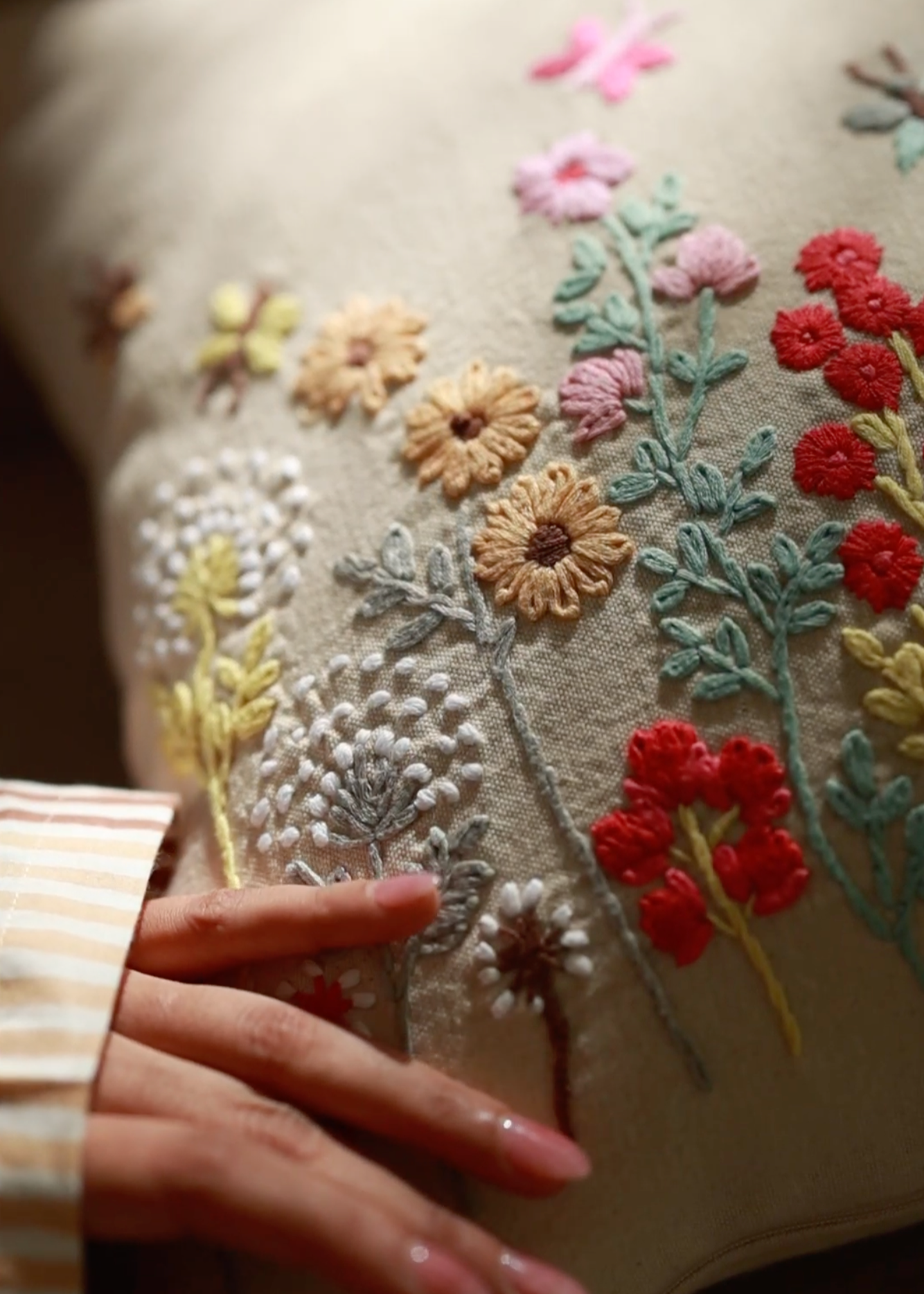 Flourish Embroidery Cushion Cover – A beautifully handwoven cotton cushion cover featuring intricate hand embroidery. Every floral detail is meticulously stitched, bringing texture and artistry to life. A true celebration of craftsmanship, adding warmth and elegance to any space.